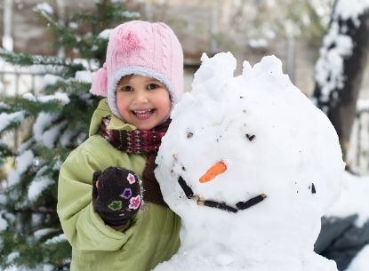 girl beside snowman