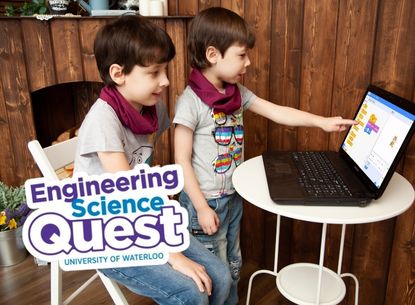Two children coding on a laptop